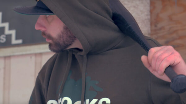 A scene from the new Locust video Yallreadykno which shows the rapper holding a bat.