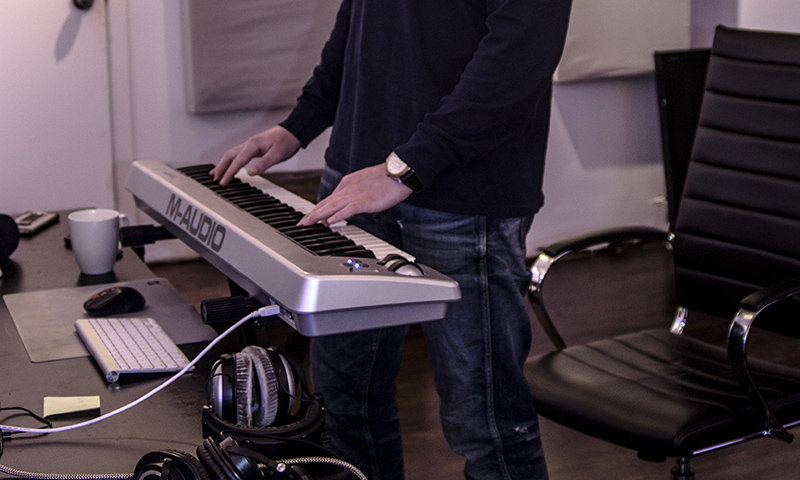 Vancouver producer DEO is seen working at his keyboard, presumably producing a beat.