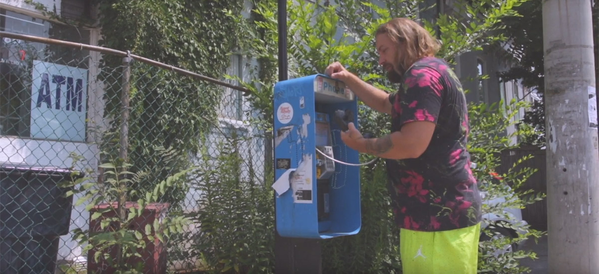 Fortunato picks up the receiver at a payphone in his new music video for Its On Now
