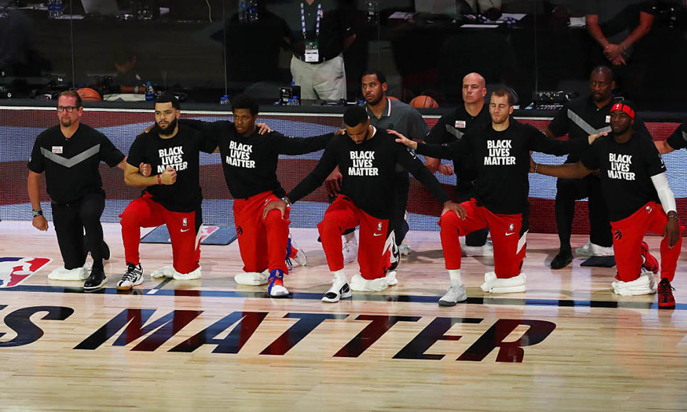 The Raptors kneel for the national anthems before Game 4 against the Brooklyn Nets