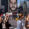 Nike ad in New York in 2018, showing former San Francisco 49ers quarterback Colin Kaepernick after his 2016 kneeling protest. Could a corporation sell an act like Kaepernick's 'kneel' as an NFT? (AP Photo/Mark Lennihan)