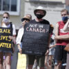Protesters march and hold up posters along the streets of Hamilton to support anti racism and Black Lives Matter. (Shutterstock)