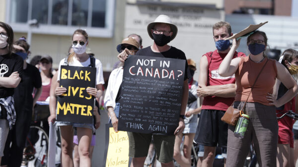 Protesters march and hold up posters along the streets of Hamilton to support anti racism and Black Lives Matter. (Shutterstock)