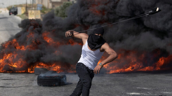 A Palestinian protester uses a slingshot during clashes with Israeli soldiers (Photo: AP Photo/Nasser Nasser)