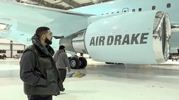 Drake stands next to his private jet Air Drake
