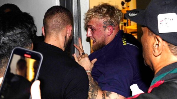 Jake Paul is pushed into a closet to get him away from boxer Floyd Mayweather Jr. after a scuffle broke out during a news conference. (Photo: AP Photo/Marta Lavandier)
