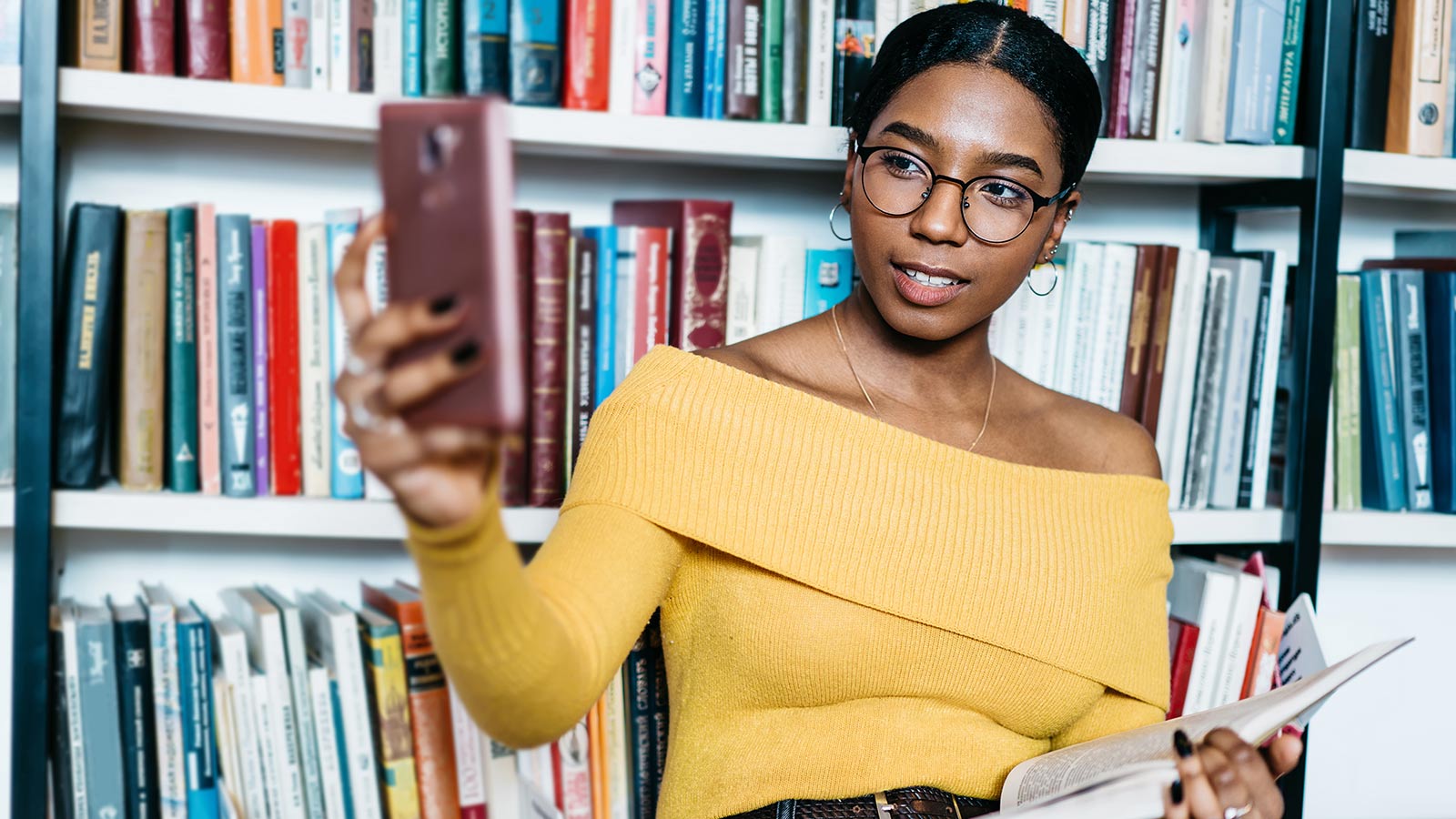 A woman holding up her smartphone