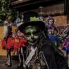 A group of people wear costumes to celebrate the Day of the Dead