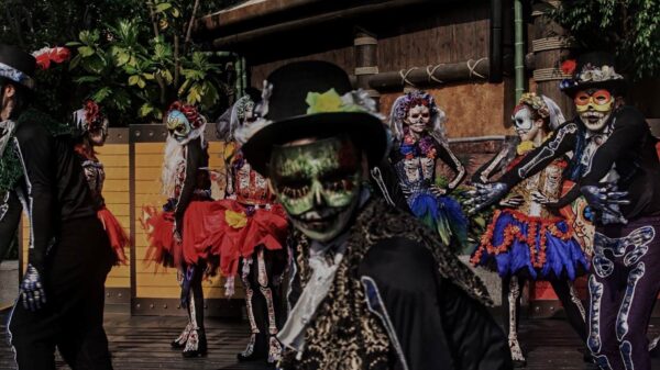 A group of people wear costumes to celebrate the Day of the Dead