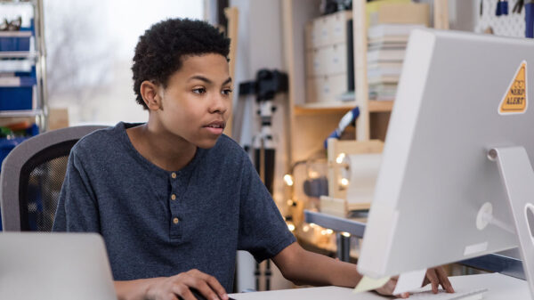 A young boy uses a computer