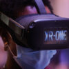A Black woman wearing a VR set (Photo: Carlos Costa/AFP via Getty Images)
