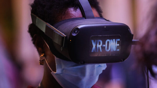 A Black woman wearing a VR set (Photo: Carlos Costa/AFP via Getty Images)