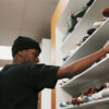 Slim Dinero browsing a shoe store