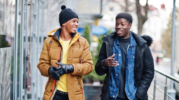 Two Black youths walking and talking