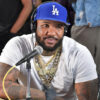 The Game wearing a blue LA Dodgers hat while doing an interview