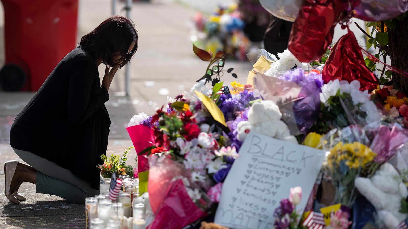 A woman mourns at memorial to the victims of the mass shooting at a Buffalo, N.Y.,