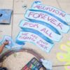 An abortion-rights activist writes the words Abortion Forever For All in chalk