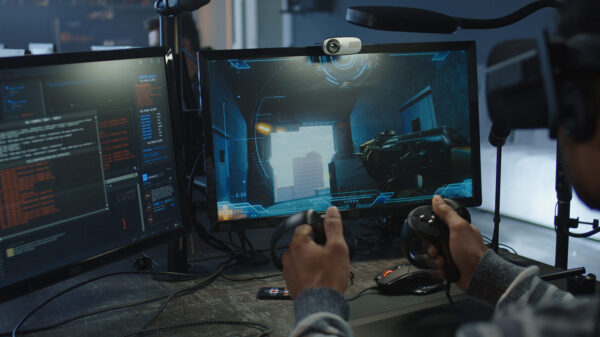 An over the shoulder view of a man playing a video game