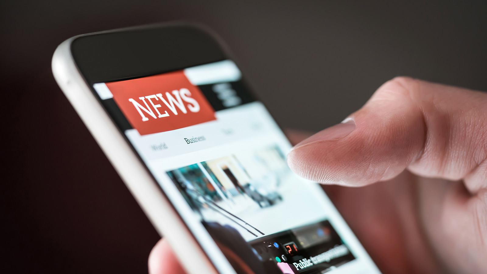 A mobile phone user reads the news