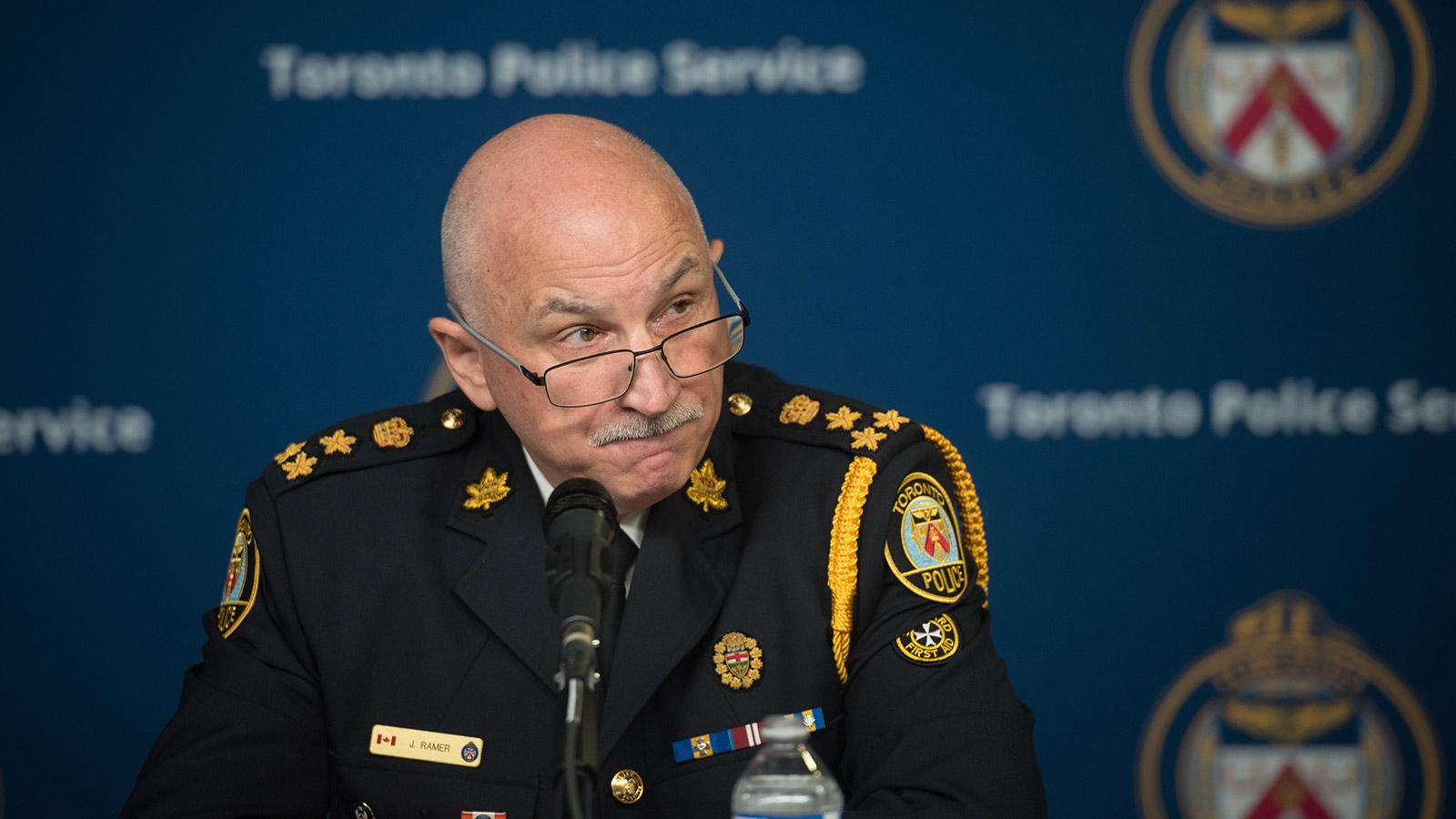 Police Chief James Ramer speaks at a podium during a news conference