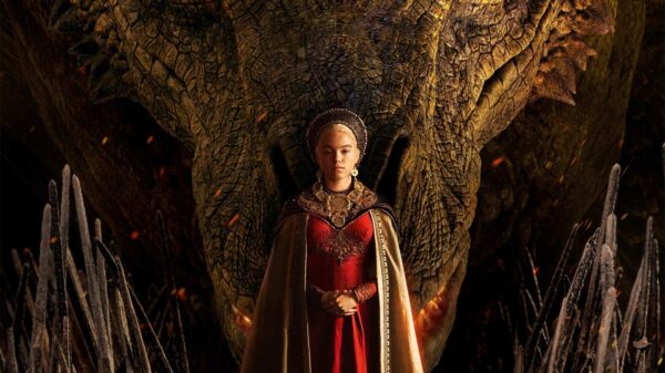 A young woman stands in front of a large Dragon head