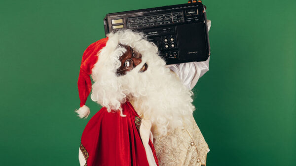 A Black Santa Claus holding a boombox