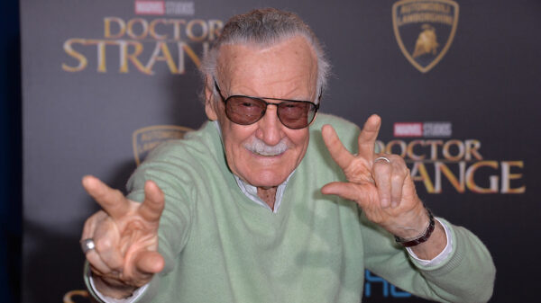 Stan Lee poses on the red carpet for the movie Doctor Strange in 2016.