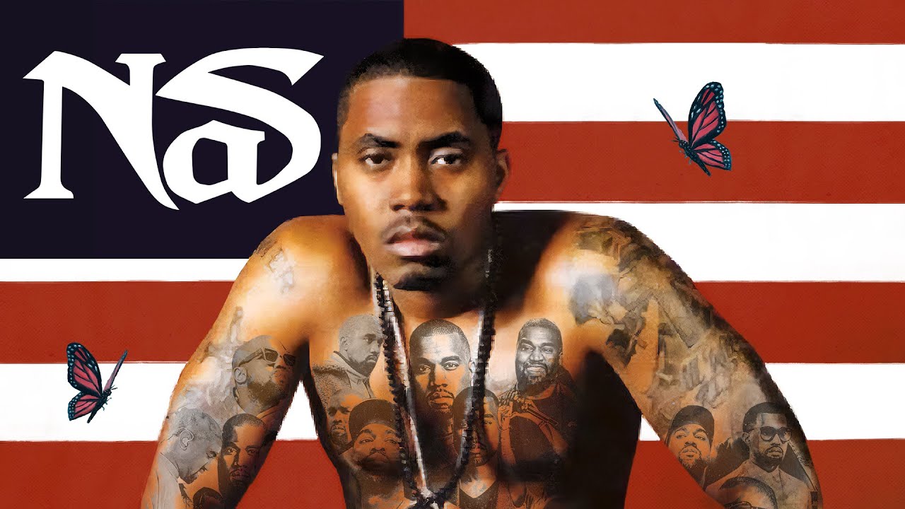 Nas sits in front of an U.S. flag with the stars of the flag replaced by the Nas logo