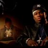 50 Cent in a New York Yankees fitted hat over a white bandana