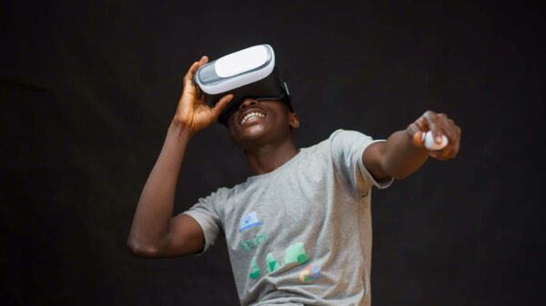 A man wearing a virtual reality headset and holding a virtual reality controller