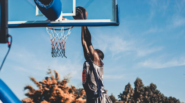 A man dunking a basketball.