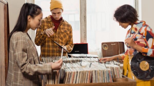 Three people digging in the crates at a record store.