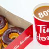 A box of Tim Hortons donuts and a cup of Tim Hortons coffee with the text '80%' super imposed on the coffee.