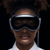 A close up of a young woman wearing an Apple Vision Pro headset