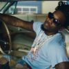 Offset behind the wheel with sunglasses on in the JEALOUSY video
