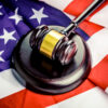 A gavel resting on an American flag