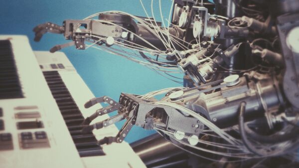 A robot playing the keyboard to represent the article's focus on how AI is changing music