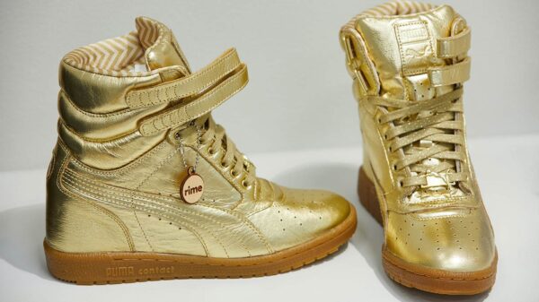 A pair of gold hightop sneakers.