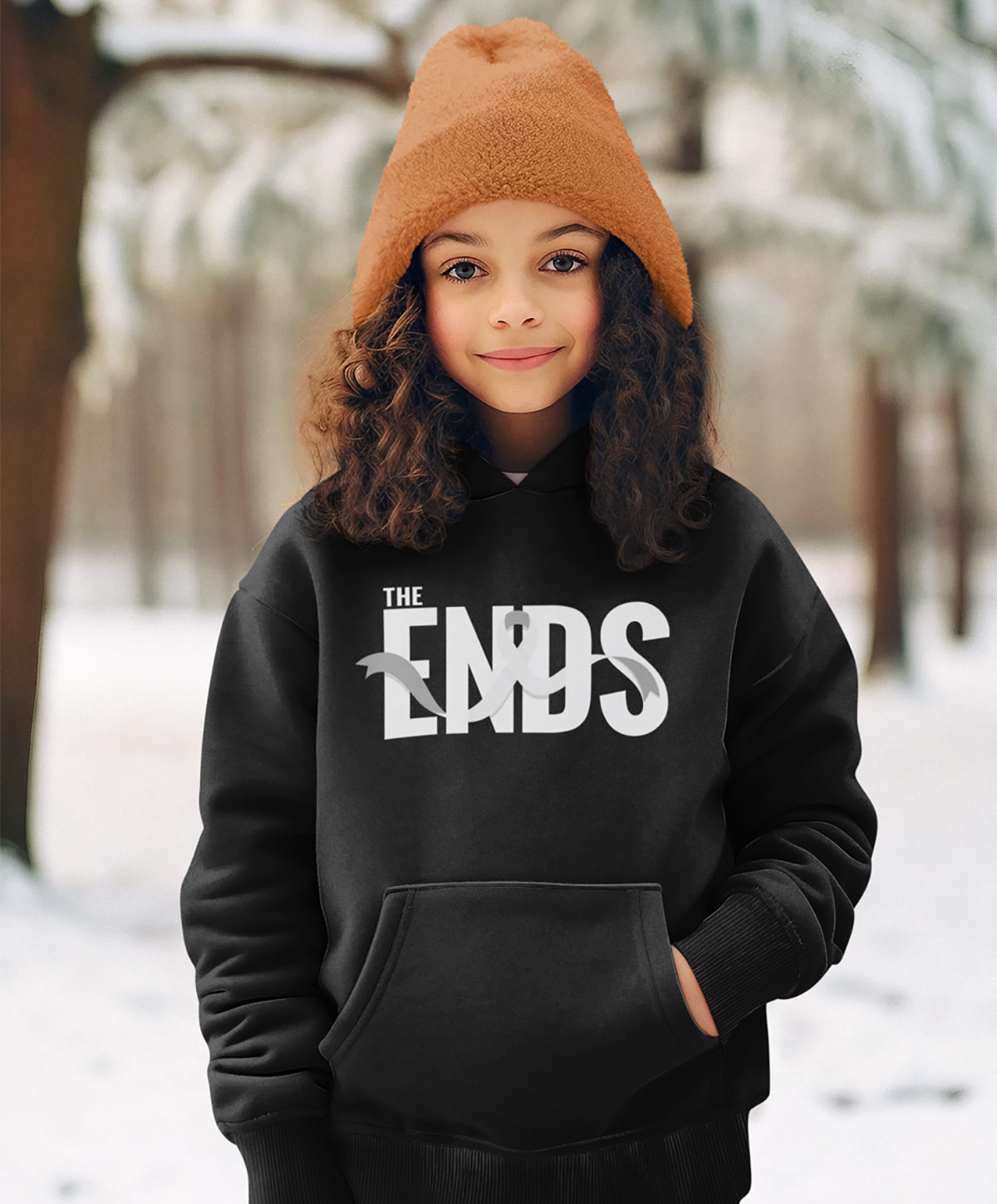 A young girl wearing a brown toque poses for a photo in a black hoodie from The Ends Fight Ribbon collection.