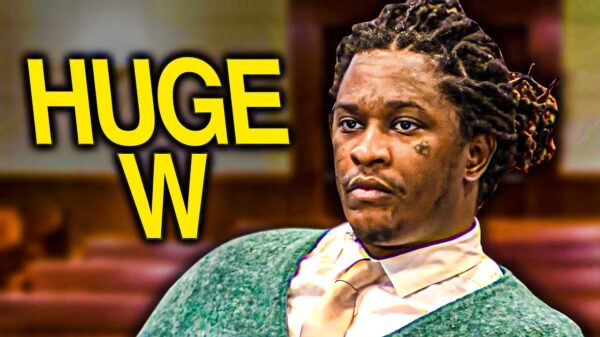 Rapper Young Thug dressed in a suit and tie during a court proceeding.