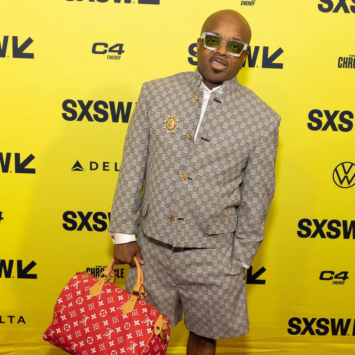 Music producer, executive and rapper Jermaine Dupri wearing designer clothes and holding a designer bag at the Freaknik premiere.