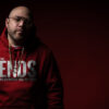 A profesional photo of rapper Bishop Brigante wearing a hoodie from his clothing line, The Ends.