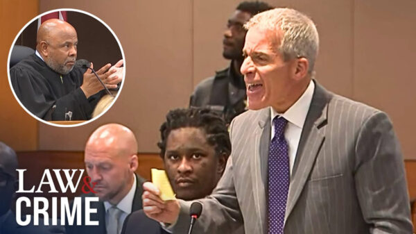 Young Thug's attorney screams at the judge in court with Young Thug seated next to him.