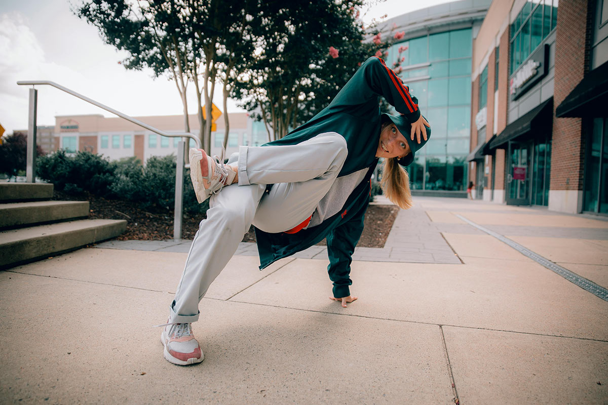 A b-girl wearing a traditional breakdancing outfit