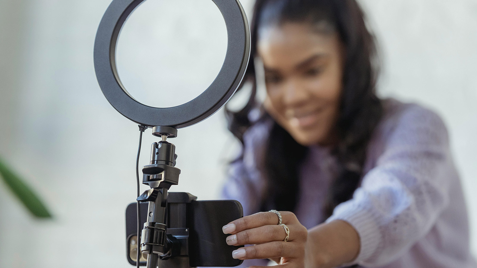 A young woman adjusts her high quality camera equipment.
