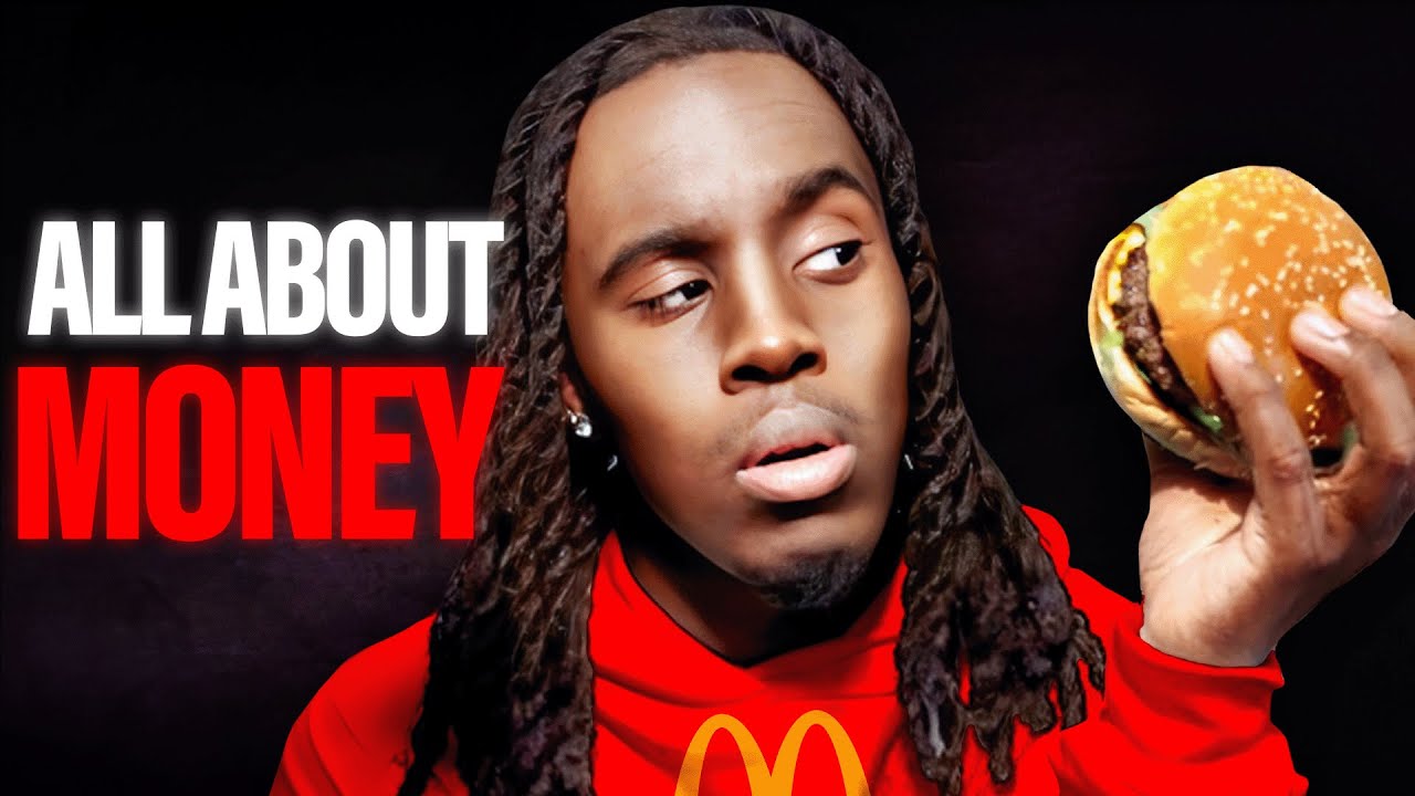 Kai Cenat wearing a McDonald's hoodie and holding a hamburger.