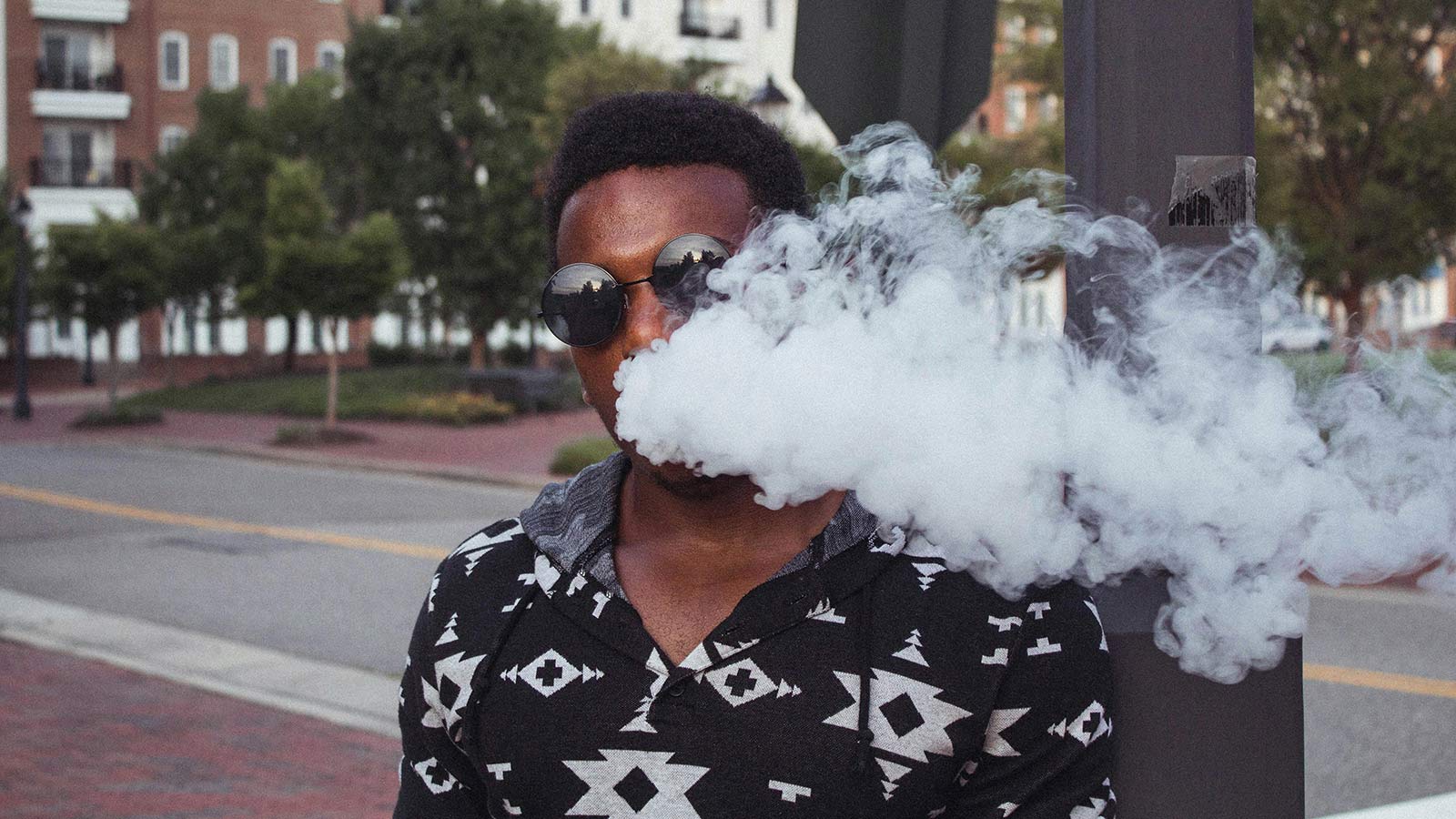 An image of a man vaping, for an article about strategies on how to quit.