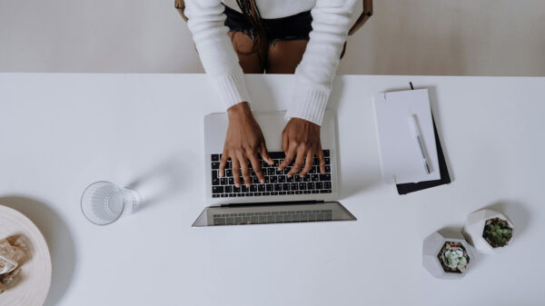 A bird's eye view of a professional Black woman using a laptop.