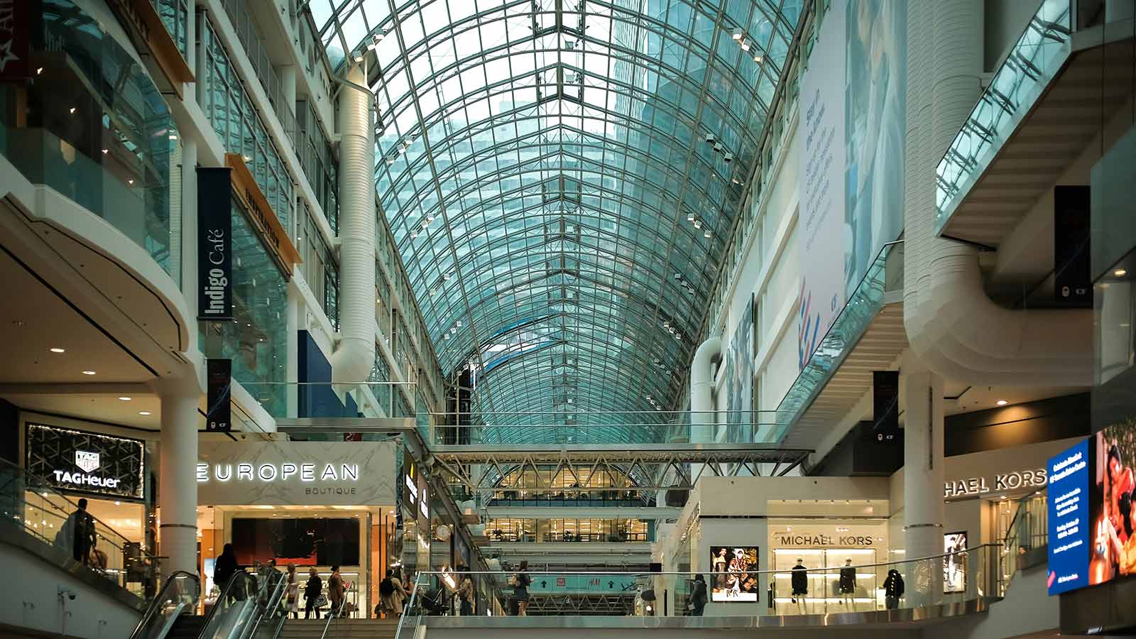 Interior view of Toronto’s Eaton Centre shopping mall with people walking and browsing stores, illustrating the growing retail energy around Singles’ Day.
