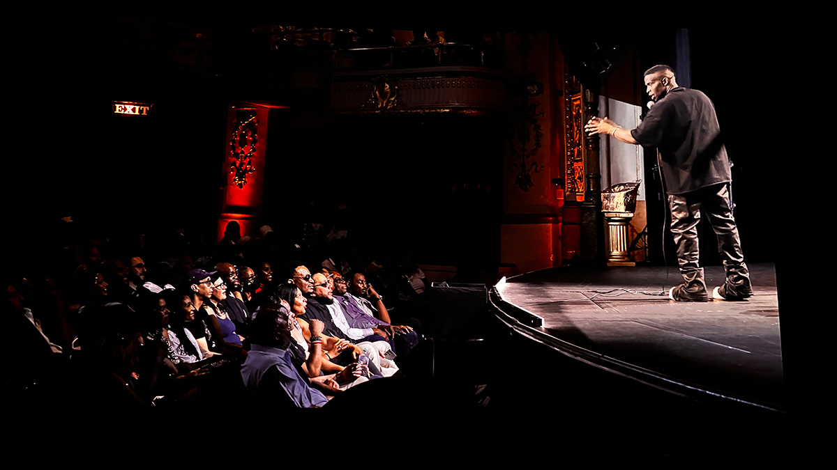 Comedian Godfrey speaks to the crowd at the screening for his new special Rebel with a Cause